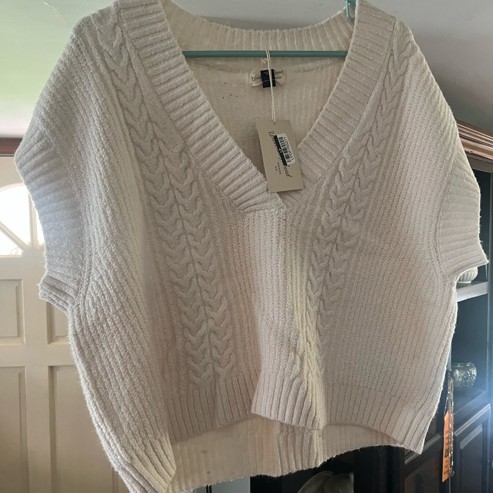 a white cable-knit, V-neck vest by Universal Thread